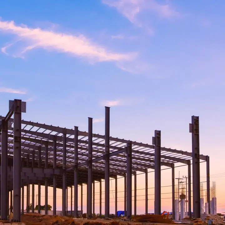 metal frame of a building against a sunset sky