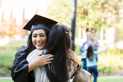 Graduate hugging