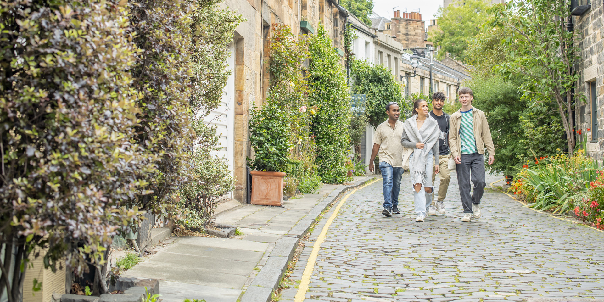 Four students walking down Circus Lane in Edinburgh