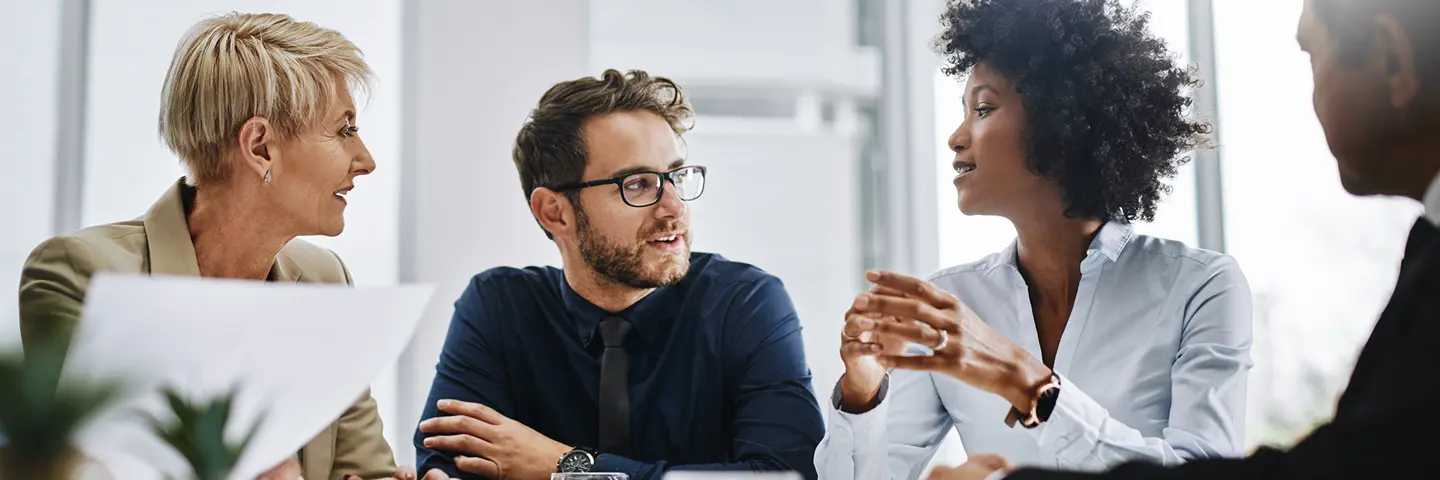 Four business people having a meeting over coffee.