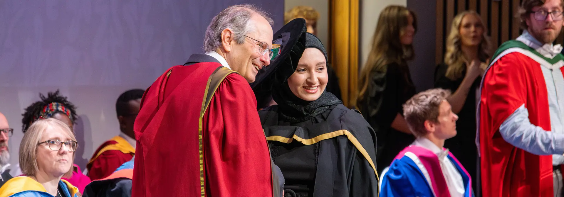 Several students in graduation robes