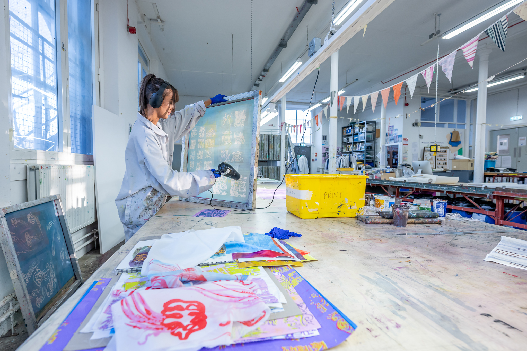 An individual with a canvas dries wet paint in an art room at our Scottish Borders campus.