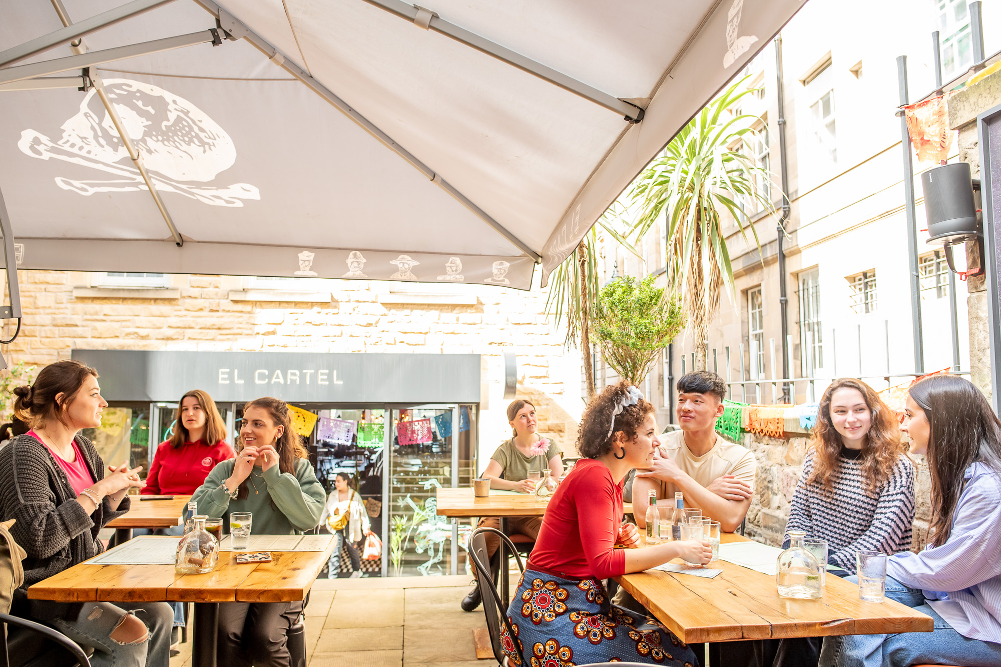Students sitting in Edinburgh city in a restaurant outside