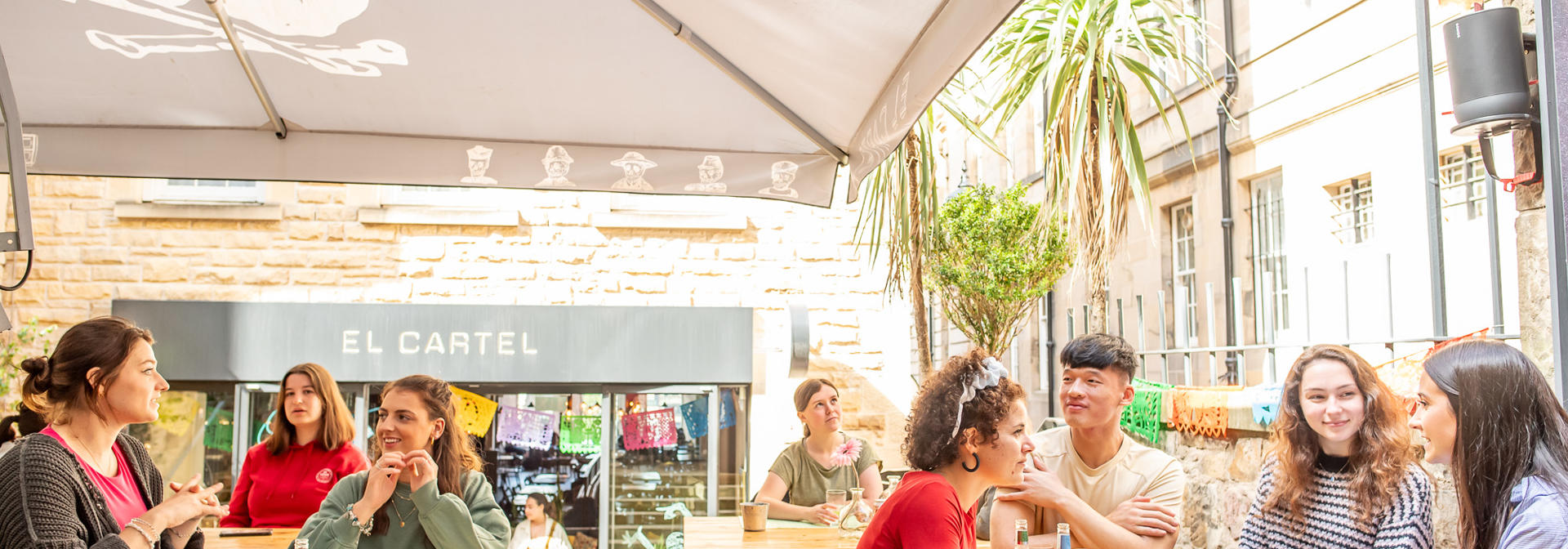 Students sitting in Edinburgh city in a restaurant outside