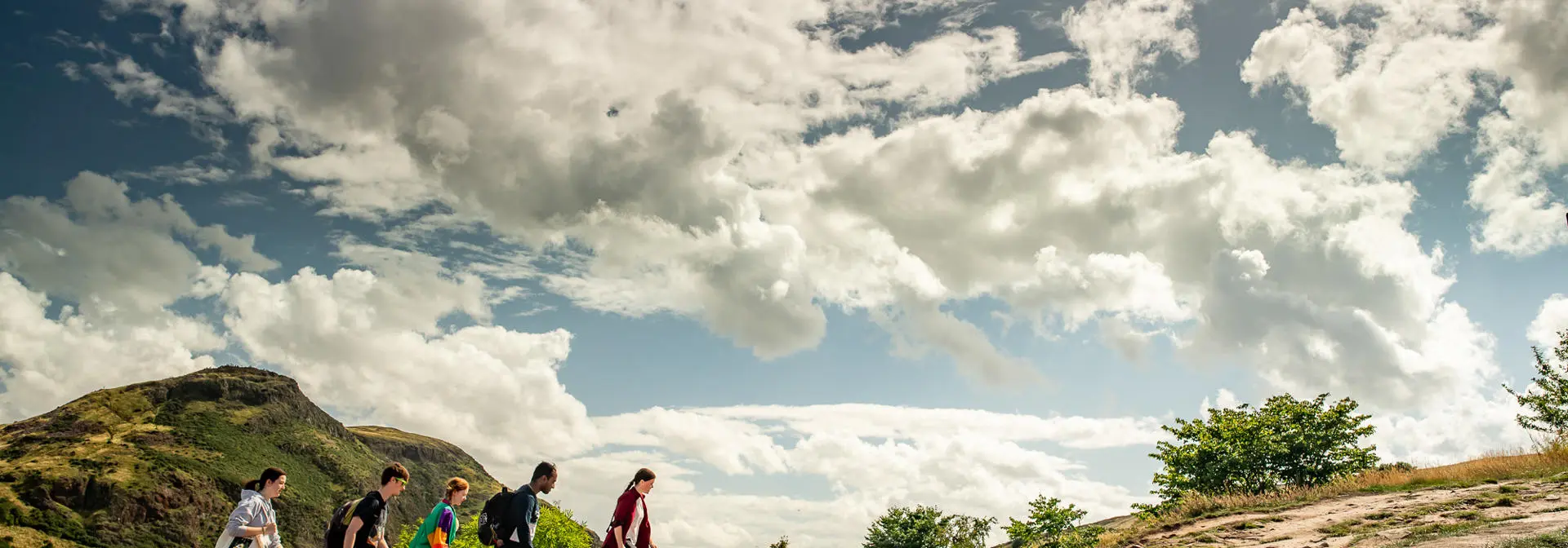 A group of students is climbing a hill