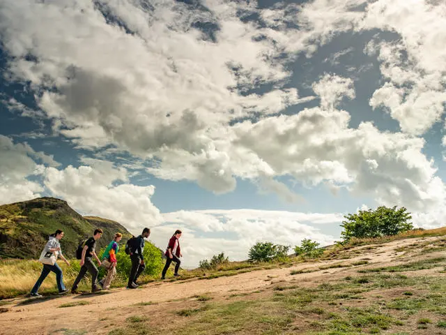 A group of students is climbing a hill