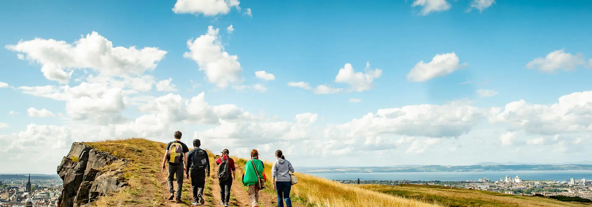 Five students walking along Arthur's Seat in Edinburgh.