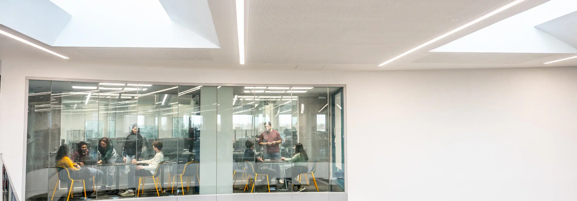 Two breakout rooms with two groups of people in meetings.