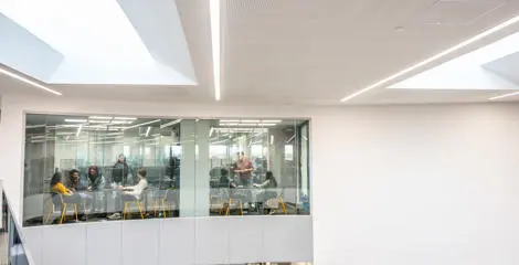 Two breakout rooms with two groups of people in meetings.