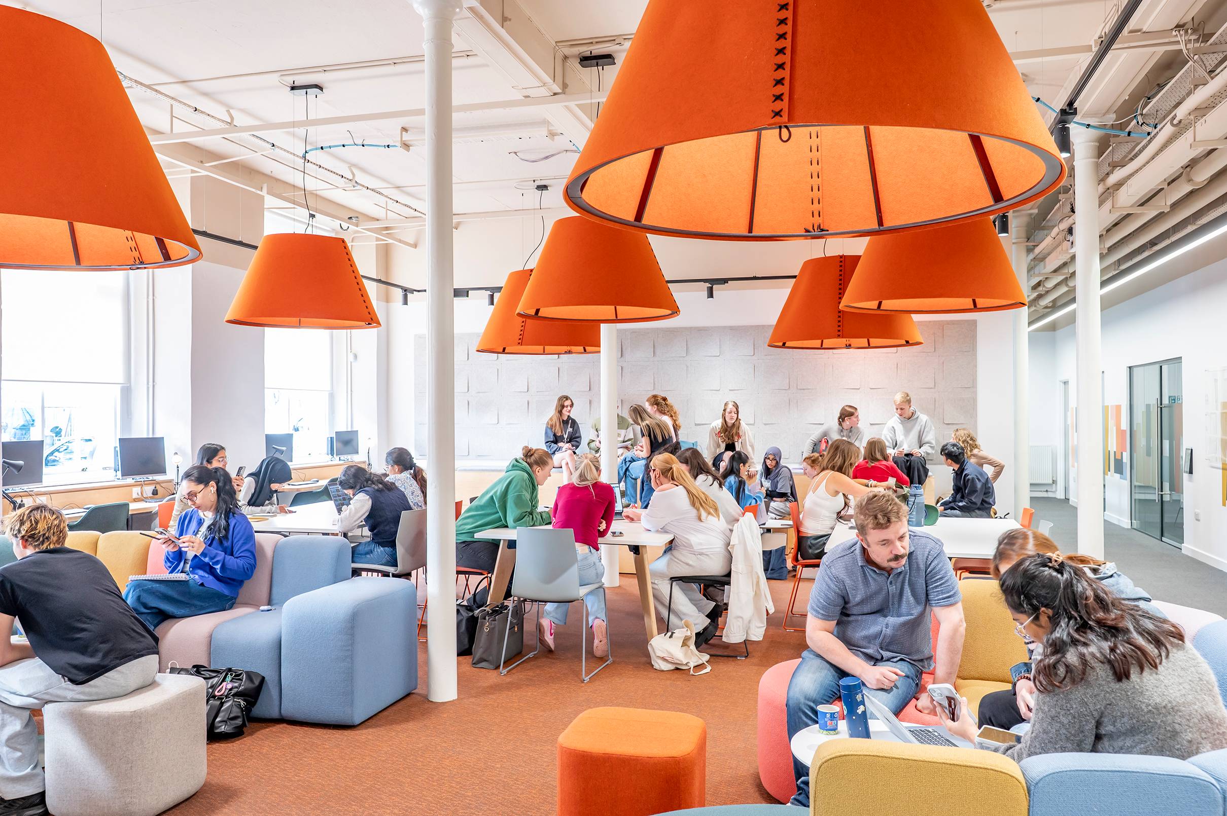 Student break-out area, busy with students working in groups