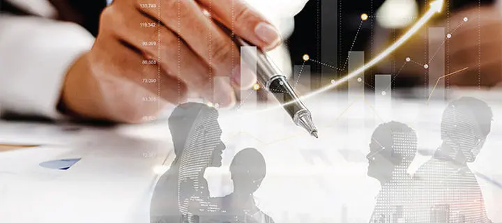 A business man's hand holding a pen alongside resource chart and images