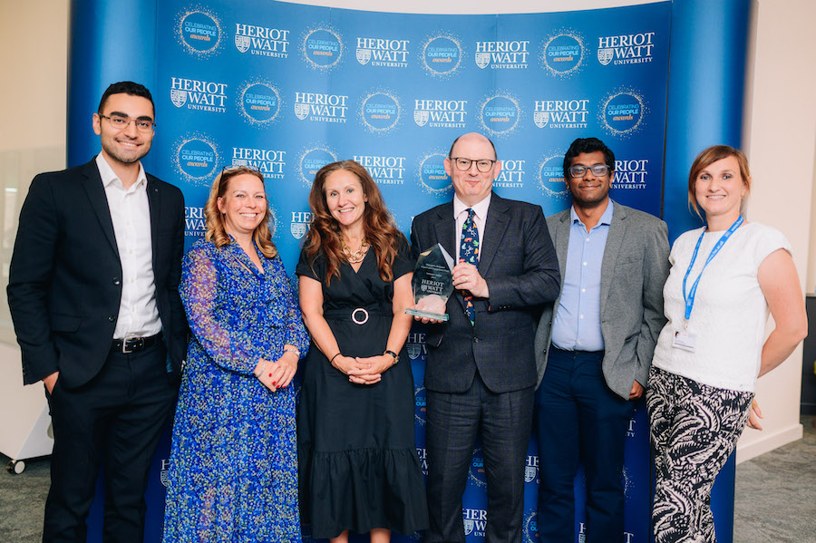 Winner of the Innovate Award, the Medical Device Manufacturing Centre team, with Prof. Gill Murray Six individuals smiling as they receive an award.