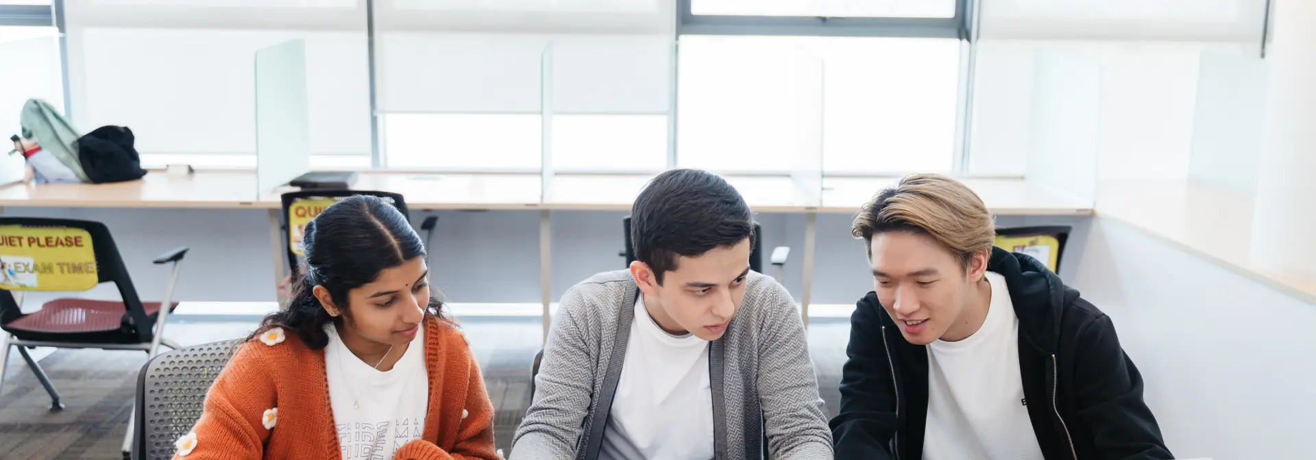 Two individuals sitting at a desk.