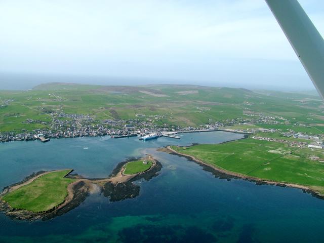 A faraway view of Orkney town and coastline