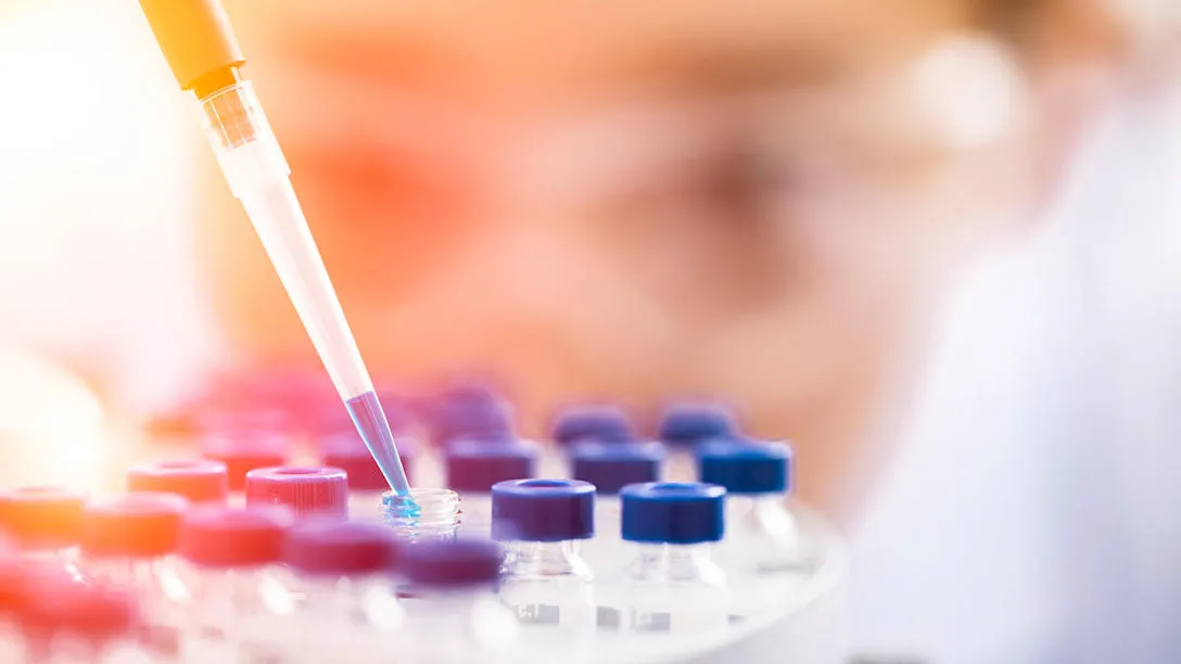 Scientist working in lab in protective clothing