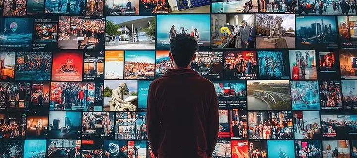 A student faces a wall of screens