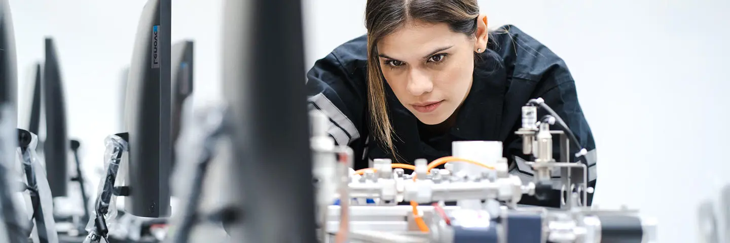A student works on a device in a computer lab.
