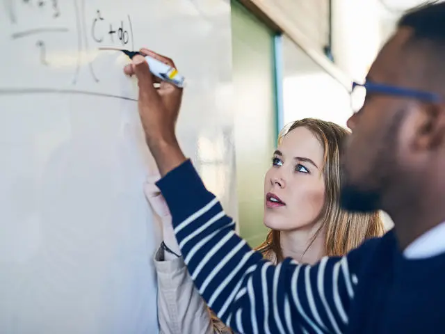 Students working on a whiteboard
