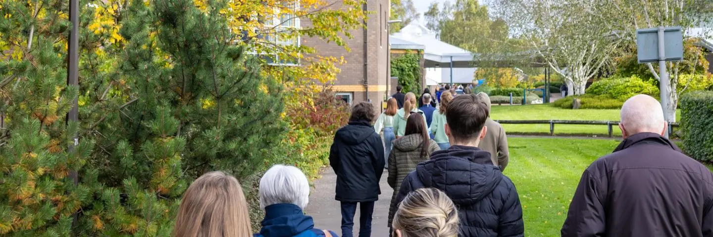 Individuals walking towards an event on Edinburgh campus