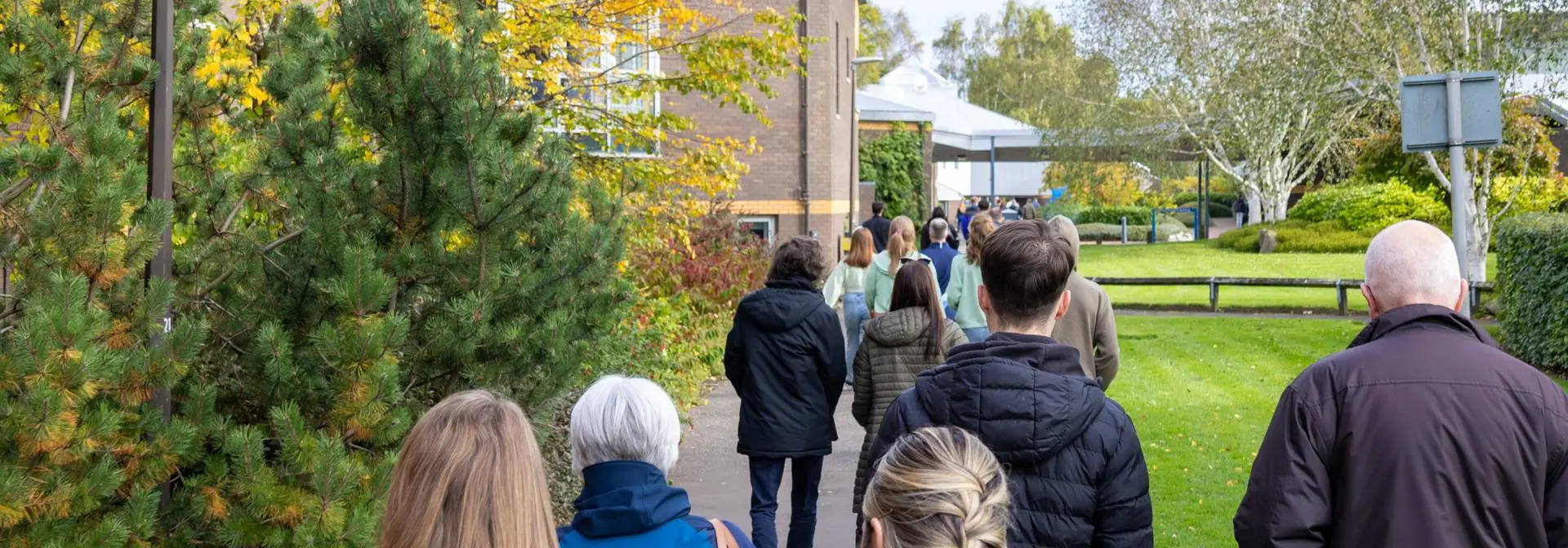 Individuals walking towards an event on Edinburgh campus