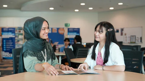 Two students in the Heriot-Watt Malaysia campus in discussion