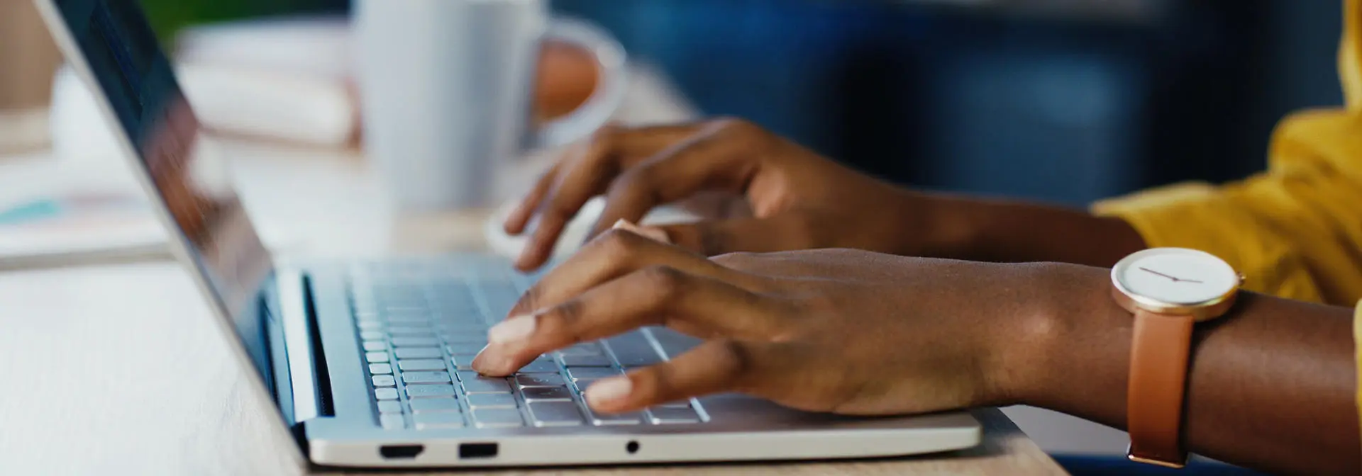 Hands working on a laptop