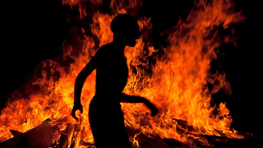 Shadow of person in front of fire