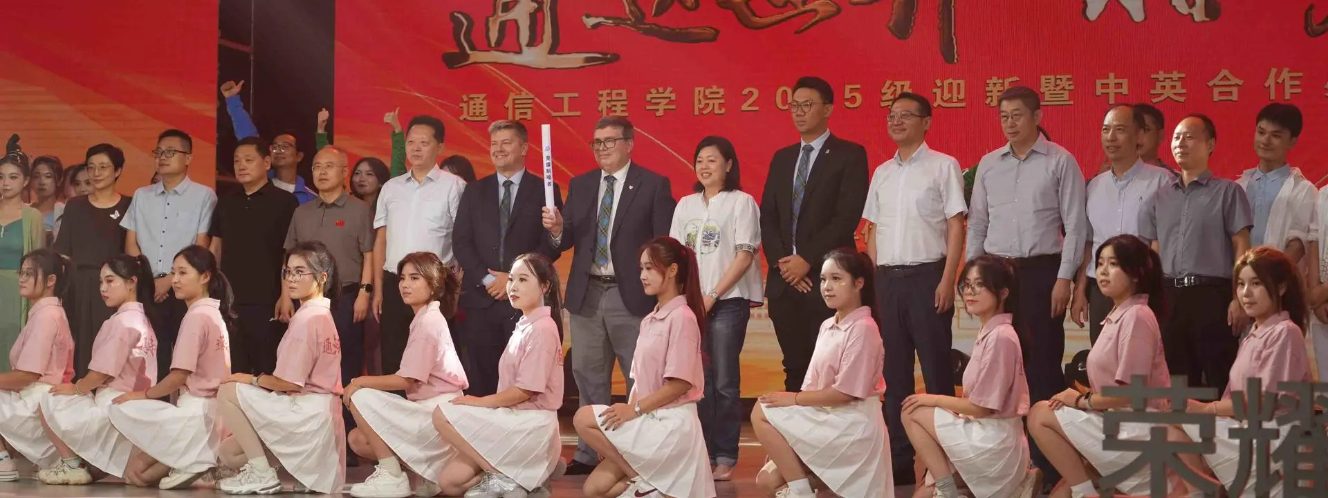 Large group shot. Professor Richard A.Williams in the centre holding a baton.
