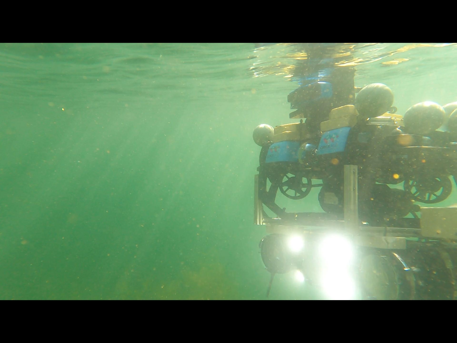 1920px Surface vessel and autonomous underwater robot undergoing trials in Heriot-Watt University's wave tank facility (GoPro stills)
