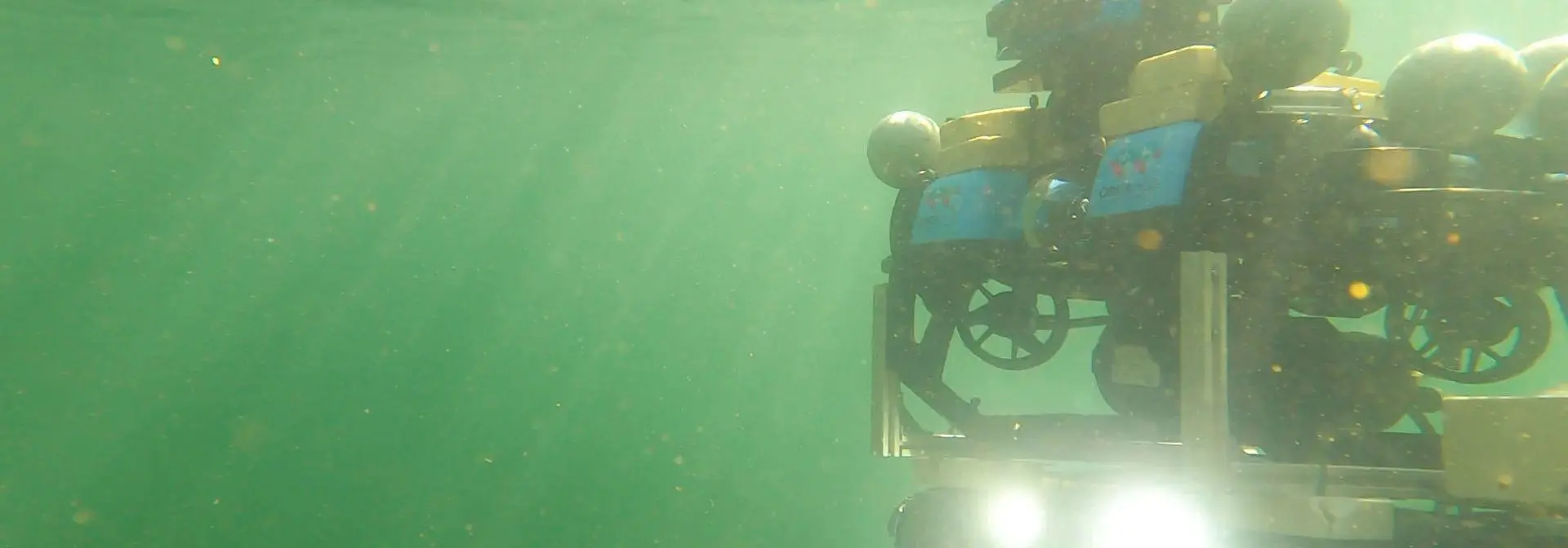 1920px Surface vessel and autonomous underwater robot undergoing trials in Heriot-Watt University's wave tank facility (GoPro stills)