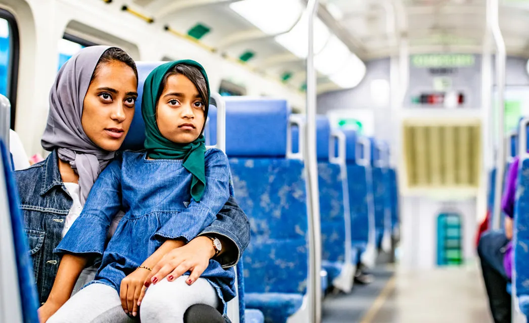 Mum and child on a bus. Photo by FatCamera.