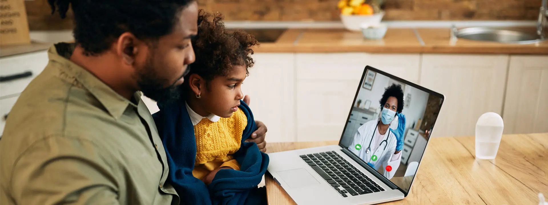 A father and child sitting at a computer.