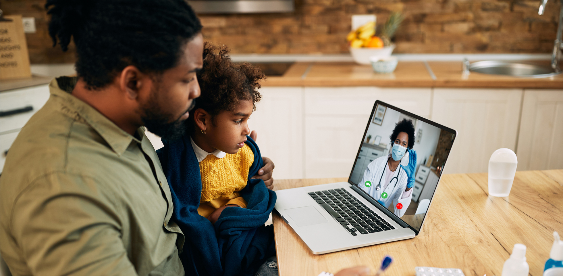 A father and child sitting at a computer.