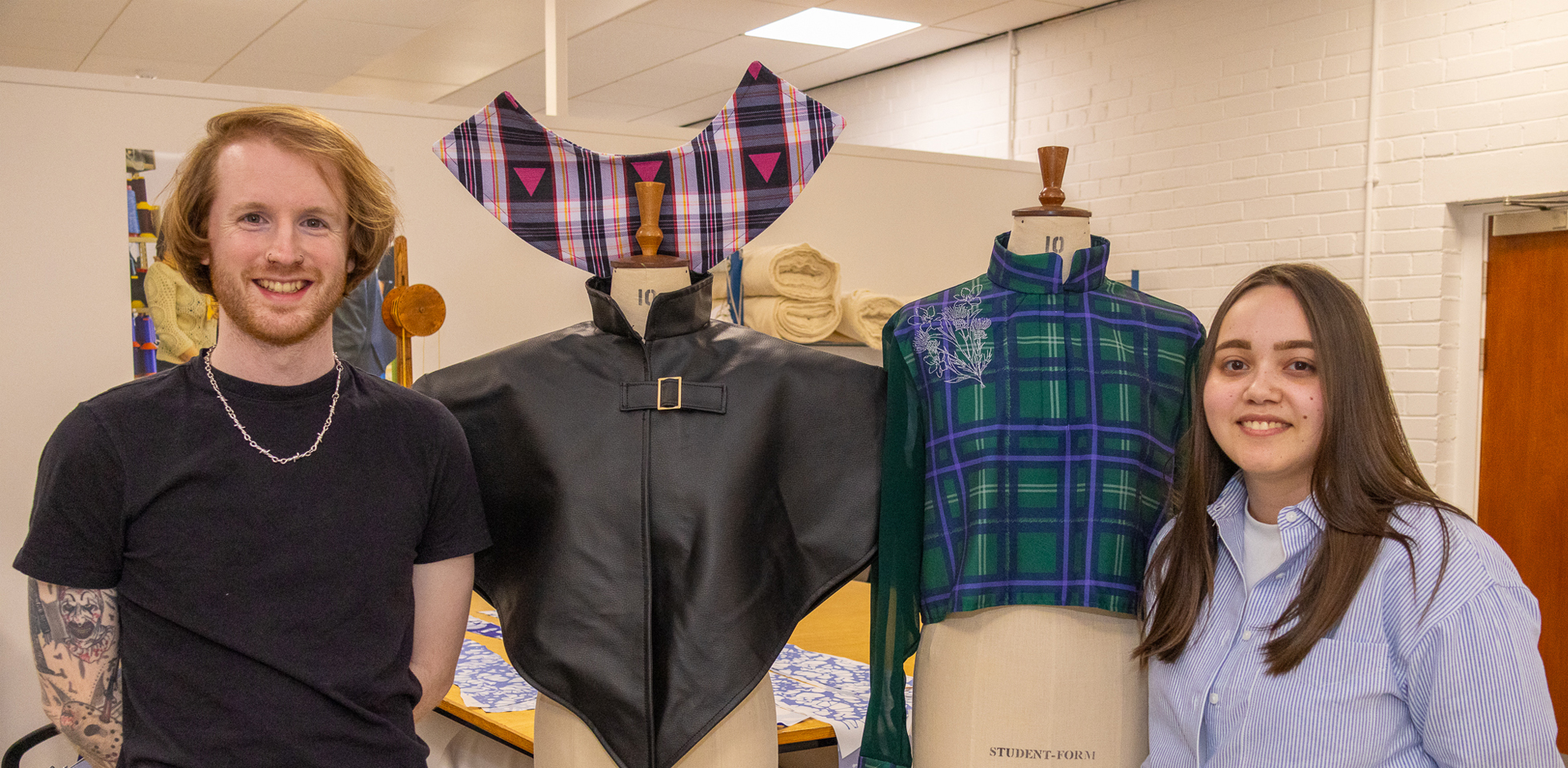 Fashion students Craig Taylor (left) and Kayleigh Wyllie with samples of their tartan designs.
