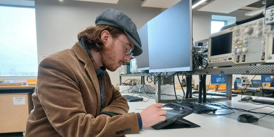 Student Sandy sitting at computer in lab