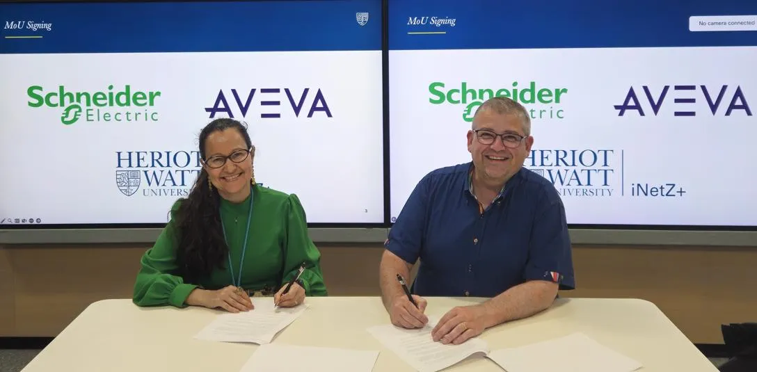 David Pownall, VP, Power Systems UK&I at Schneider Electric, and Professor Gabriela Medero, Associate Principal for Enterprise, Heriot-Watt University, sign the MoU at Heriot-Watt University’s Edinburgh campus on Tuesday 2 June. Two people singing an MoU and looking/ smiling towards camera