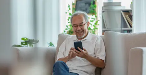 A person sitting using a mobile phone.