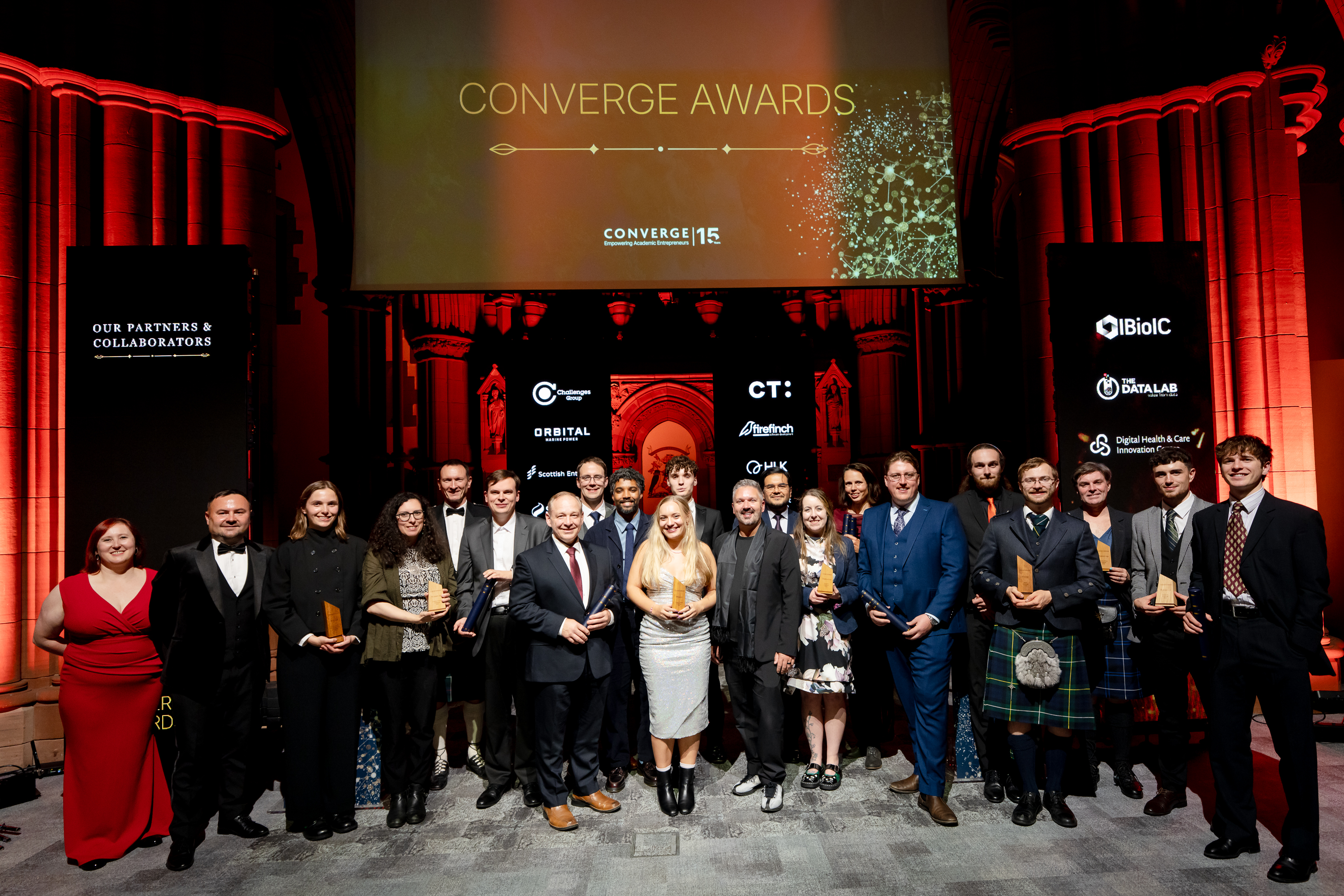 A group of award winners holding prizes