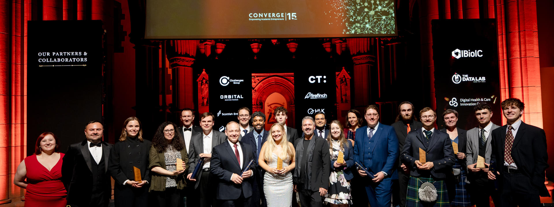 A group of award winners holding prizes