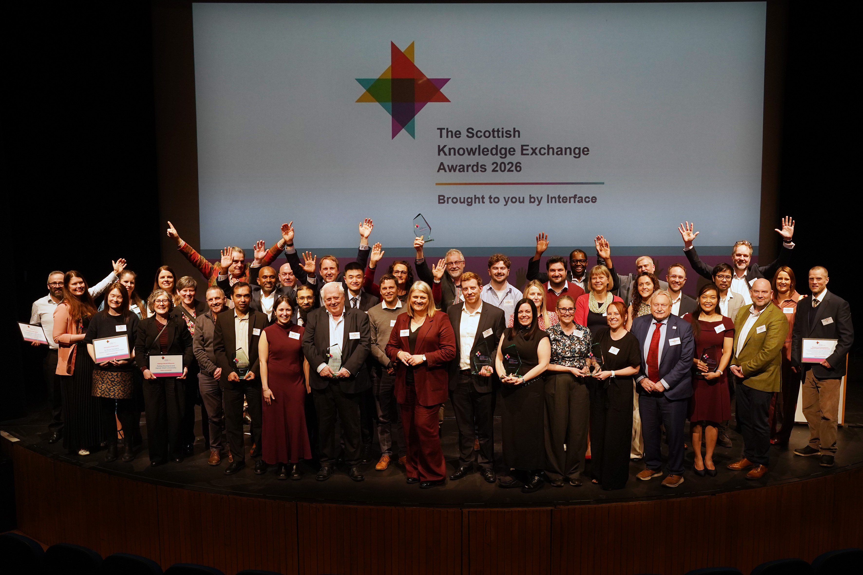 A group of people on stage at an awards ceremony 
