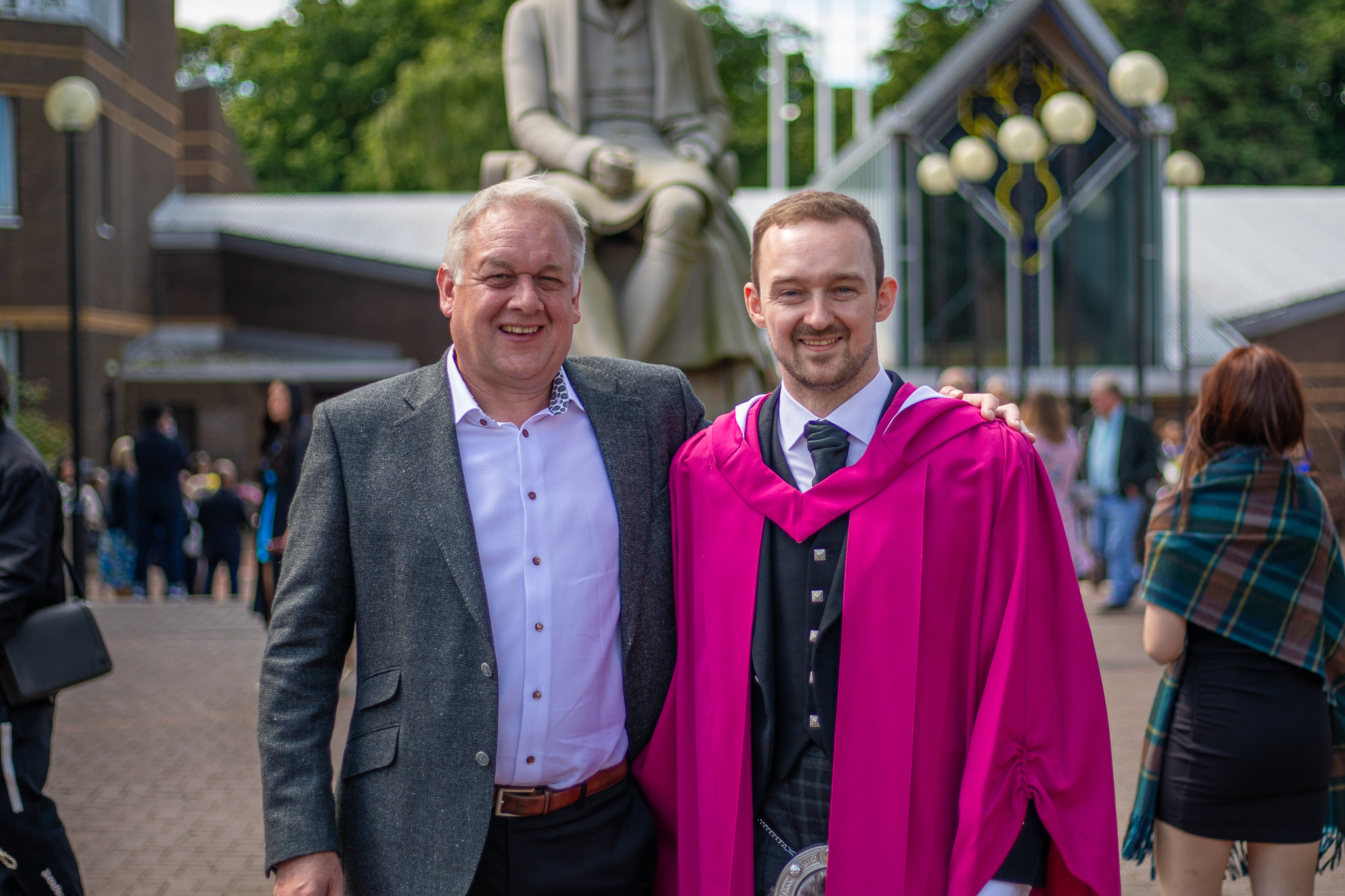 Angus Addlesee in his graduation gown with his father, Robert.