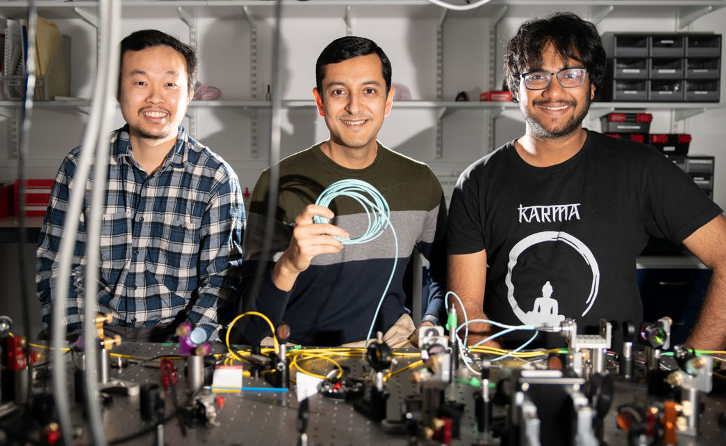 Professor Malik with members of Heriot-Watt’s Beyond Binary Quantum Information Lab (BBQLab), Dr Saroch Leedumrongwatthanakun (left) and PhD student Suraj Goel (right). Professor Malik with members of Heriot-Watt’s Beyond Binary Quantum Information Lab (BBQLab), Dr Saroch Leedumrongwatthanakun (left) and PhD student Suraj Goel (right).