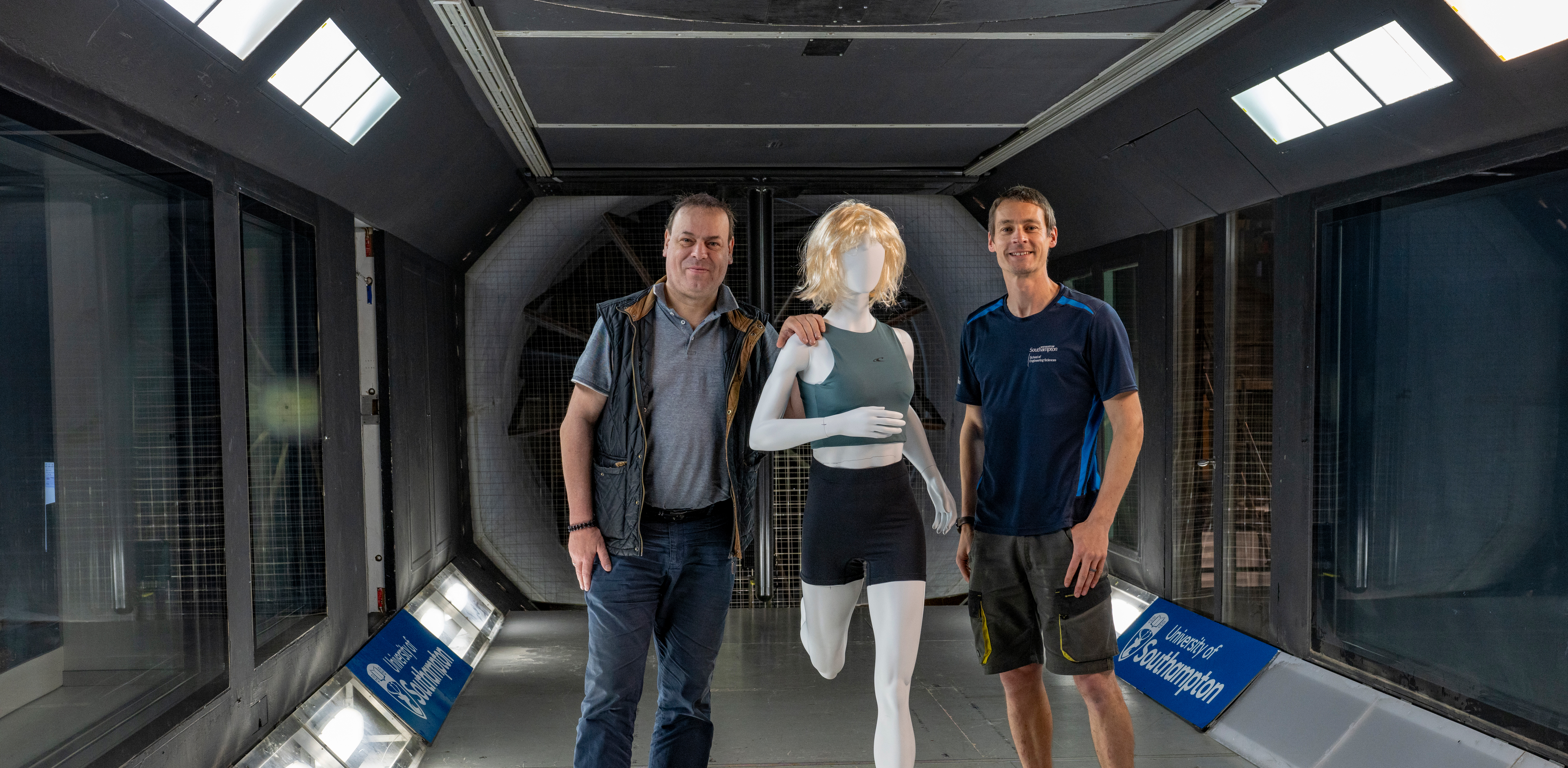 Professor Bert Blocken (left) with Dr David Marshall stand in the wind tunnel with a static test mode between them.