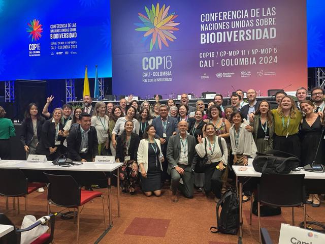 A large group of people posing at the United Nations Biodiversity Conference (COP16) in Cali, Colombia, 2024.