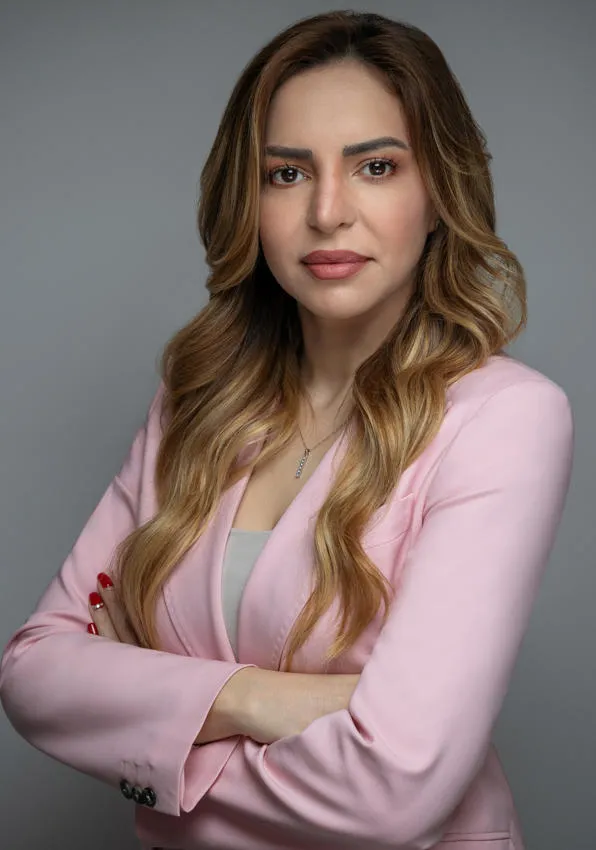 Dr Rula Sharqi Dr Rula Sharqi pictured with her arms crossed, facing the camera.