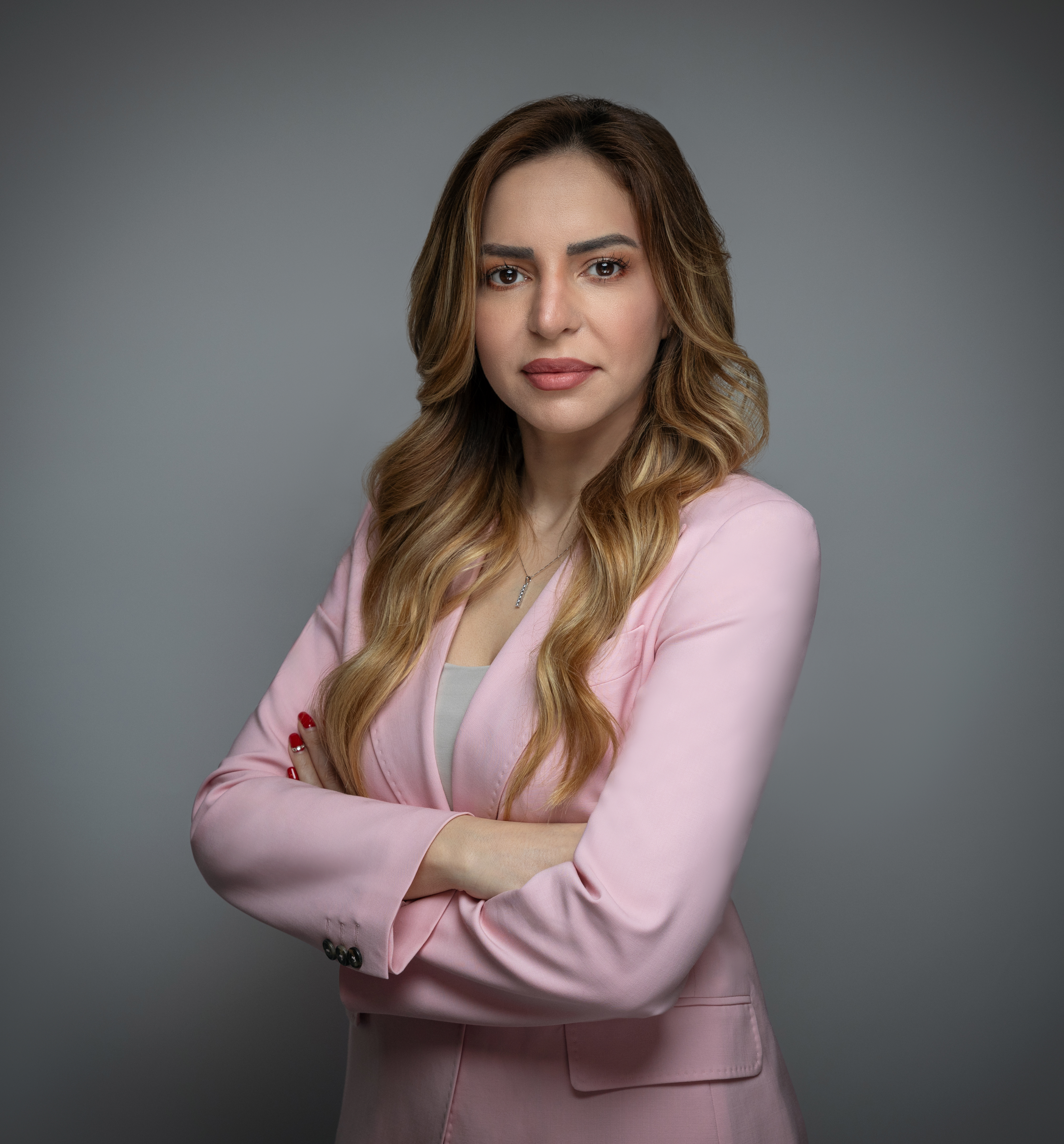 Dr Rula Sharqi pictured with her arms crossed, facing the camera.