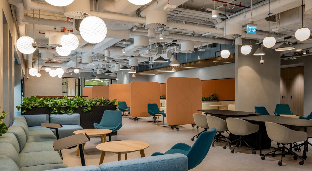 lounge chairs and tables in a closed warmly lit room