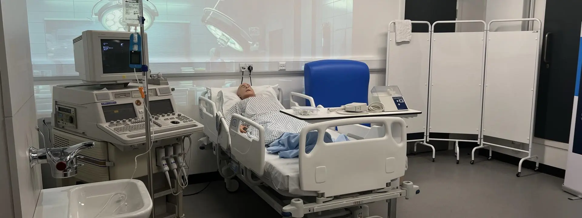 Alex robot in simulated hospital bed environment