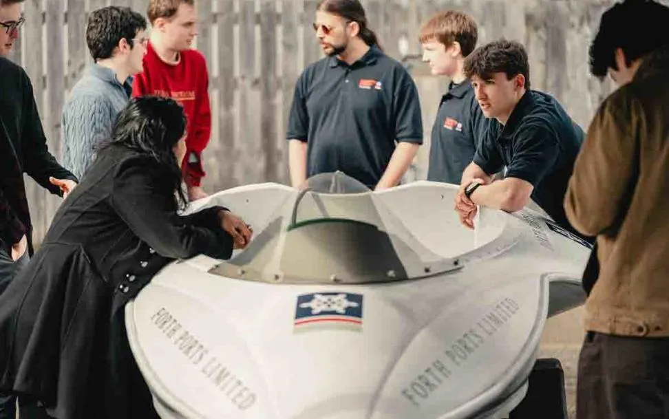 The Heriot - Watt team will be competing at the Monaco Energy Boat Challenge in July. Images shows a member of the student team leaning on the boat.