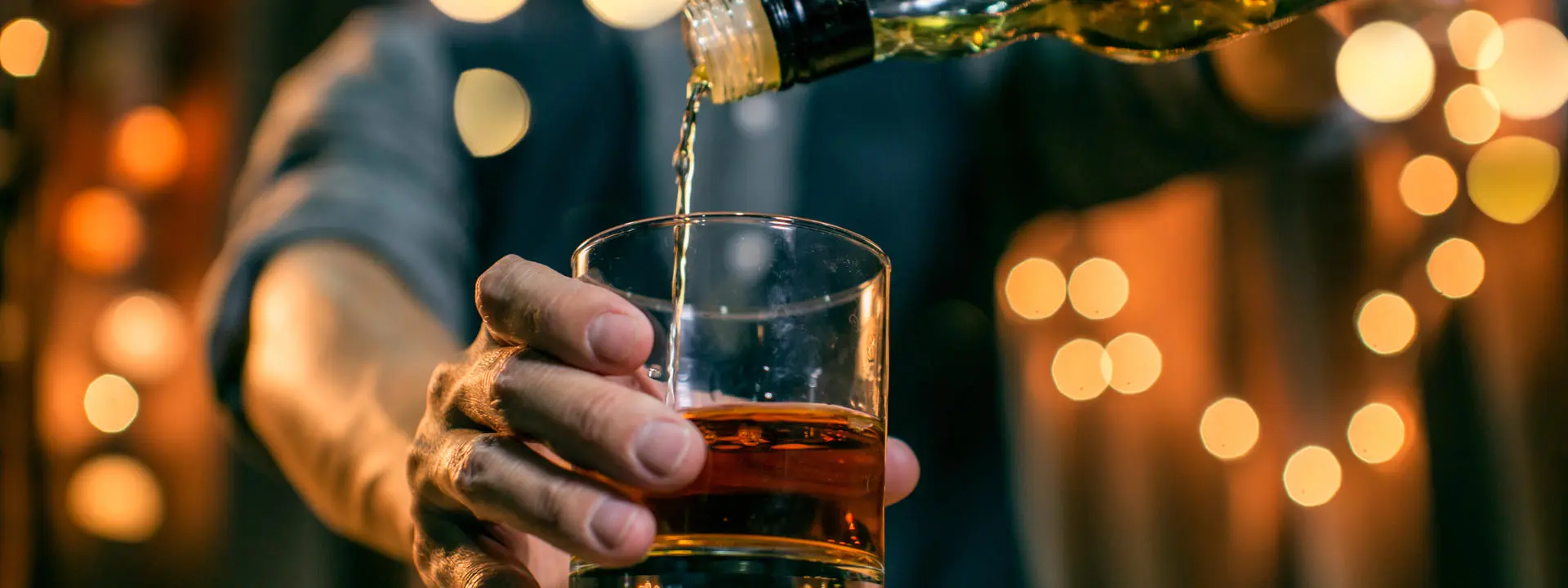 A glass of whisky being poured